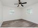 Well-lit bedroom featuring wood-look flooring, two windows, and a ceiling fan at 20797 Roberts Dr, Sheridan, IN 46069