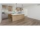 Chic kitchen with a white countertop island, modern lighting, and stainless steel appliances and wood cabinets at 20797 Roberts Dr, Sheridan, IN 46069