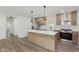 Updated kitchen with center island, wood-look flooring and stainless steel appliances at 20797 Roberts Dr, Sheridan, IN 46069