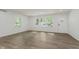 Sunlit living room with wood look floors and white walls, with plenty of natural light from windows at 20797 Roberts Dr, Sheridan, IN 46069