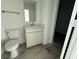 Well-lit bathroom features a modern vanity, mirror, and a toilet with tiled floors enhancing the sleek design at 2954 Grand Rdg Dr, Greenwood, IN 46143
