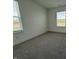 Bright bedroom featuring two windows and carpet, perfect for customization into a cozy retreat at 2954 Grand Rdg Dr, Greenwood, IN 46143