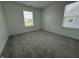 Bright bedroom features two windows, carpeted floor, and white walls making it a blank canvas for personalization at 2954 Grand Rdg Dr, Greenwood, IN 46143
