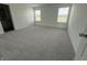 Spacious bedroom featuring soft carpeting and two bright windows, creating a comfortable and airy living space at 2954 Grand Rdg Dr, Greenwood, IN 46143