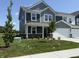 Beautiful two-story home with a well-manicured lawn, featuring mature trees and professional landscaping at 2954 Grand Rdg Dr, Greenwood, IN 46143