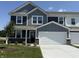 Charming two-story home with gray siding, white trim, a two-car garage, and a well-maintained front lawn at 2954 Grand Rdg Dr, Greenwood, IN 46143