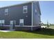 The back of this two-story home showcases modern gray siding, bright windows, and a sliding glass door to the back patio at 2954 Grand Rdg Dr, Greenwood, IN 46143