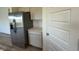 Kitchen featuring stainless steel fridge and bright white cabinets providing ample storage and sleek style at 2954 Grand Rdg Dr, Greenwood, IN 46143