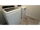 Laundry room with a new washer and dryer set, featuring modern appliances and durable flooring at 2954 Grand Rdg Dr, Greenwood, IN 46143