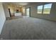 Inviting living room featuring gray carpeting, large windows, and an open layout perfect for entertaining guests at 2954 Grand Rdg Dr, Greenwood, IN 46143