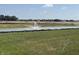 Scenic view of a pond with a fountain, surrounded by green grass and trees in a peaceful community setting at 2954 Grand Rdg Dr, Greenwood, IN 46143