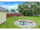 Lush backyard includes a fire pit, shed, and ample green space for recreation and relaxation at 3038 S Richardt Ave, Indianapolis, IN 46239