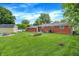 Expansive backyard featuring a shed, manicured lawn, and garden bed, perfect for outdoor enjoyment at 3038 S Richardt Ave, Indianapolis, IN 46239