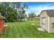 Large backyard with a storage shed, garden bed, and ample green space for outdoor activities at 3038 S Richardt Ave, Indianapolis, IN 46239