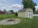 The backyard has a shed, fire pit, and a chain link fence at 3038 S Richardt Ave, Indianapolis, IN 46239