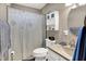 A bathroom with a sink, toilet, shower, and cabinet at 3038 S Richardt Ave, Indianapolis, IN 46239