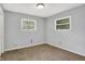 A bedroom with carpet, two windows and light walls at 3038 S Richardt Ave, Indianapolis, IN 46239