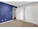 Bedroom with carpet, closet doors and blue accent wall at 3038 S Richardt Ave, Indianapolis, IN 46239