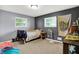 A bedroom with carpet, two windows, light and dark walls, and a ceiling light at 3038 S Richardt Ave, Indianapolis, IN 46239