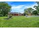 Well-maintained single-story home with a lush front yard and a covered parking area at 3038 S Richardt Ave, Indianapolis, IN 46239