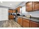 Kitchen featuring brown cabinets, modern appliances, and vinyl floors at 3038 S Richardt Ave, Indianapolis, IN 46239