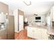 Open concept living and kitchen area with stainless steel refrigerator and hardwood floors at 3147 Bonham Dr, Indianapolis, IN 46222
