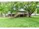Landscaped backyard with deck overlooking yard and fence at 317 Heritage Ct, Fishers, IN 46038