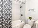 Modern bathroom features a shower over tub, gray shower curtain, and tiled shower walls at 317 Heritage Ct, Fishers, IN 46038