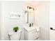 Half bath boasts a modern vanity, square mirror with lighting, and decorative accents at 317 Heritage Ct, Fishers, IN 46038