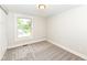 Bright and simple bedroom featuring large window and light gray carpeting at 317 Heritage Ct, Fishers, IN 46038
