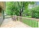 Wooden deck with chairs overlooks the backyard and mature shade trees at 317 Heritage Ct, Fishers, IN 46038