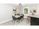 Bright dining room with grey walls and wooden table, featuring stylish chairs and modern light fixture at 317 Heritage Ct, Fishers, IN 46038