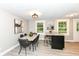Bright dining area with modern light fixture and lots of natural light from windows overlooking backyard at 317 Heritage Ct, Fishers, IN 46038
