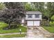 Inviting two-story home featuring tidy landscaping, a two-car garage, and blue shutters at 317 Heritage Ct, Fishers, IN 46038