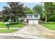 Charming two-story home featuring tidy landscaping, a two-car garage, and blue shutters at 317 Heritage Ct, Fishers, IN 46038