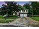 Charming two-story home with a two-car garage, gray siding, brick facade, and well manicured lawn at 317 Heritage Ct, Fishers, IN 46038