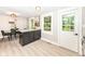 Open kitchen and breakfast nook with granite counters, white cabinets and stainless appliances at 317 Heritage Ct, Fishers, IN 46038