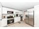 Bright kitchen featuring stainless steel appliances, white cabinetry, and laminate floors, and ample counter space at 317 Heritage Ct, Fishers, IN 46038