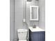 Gray basement bathroom with a modern vanity and toilet at 3322 N Riley N Ave, Indianapolis, IN 46218