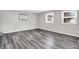A gray bedroom with new gray wood flooring and two large windows at 3322 N Riley N Ave, Indianapolis, IN 46218