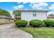 Landscaped backyard showcasing a home's well-maintained lawn and side exterior at 3322 N Riley N Ave, Indianapolis, IN 46218