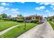 Well-maintained ranch-style home with a green lawn, long driveway, and charming curb appeal in a tranquil neighborhood at 3322 N Riley N Ave, Indianapolis, IN 46218
