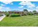 Classic ranch-style home with lush green lawn, mature shrubbery, and inviting curb appeal on a sunny day at 3322 N Riley N Ave, Indianapolis, IN 46218