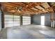 Spacious two-car garage with exposed wood ceiling and two white doors at 3322 N Riley N Ave, Indianapolis, IN 46218