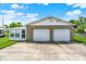 Detached two-car garage exterior with white doors and adjacent sunroom at 3322 N Riley N Ave, Indianapolis, IN 46218