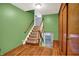 A hallway with hardwood floors and a staircase at 3322 N Riley N Ave, Indianapolis, IN 46218