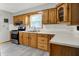 Traditional kitchen with wood cabinets, white countertops, modern appliances, and bright natural light at 3322 N Riley N Ave, Indianapolis, IN 46218