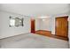 Open-concept living room with hardwood floors, plush carpet, and large decorative mirror accenting the space at 3322 N Riley N Ave, Indianapolis, IN 46218