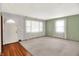 Bright living room featuring neutral walls, plush carpet, and large windows with natural light at 3322 N Riley N Ave, Indianapolis, IN 46218