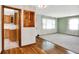 Inviting living space featuring hardwood floors, neutral walls, plush carpet and an entrance to the kitchen at 3322 N Riley N Ave, Indianapolis, IN 46218